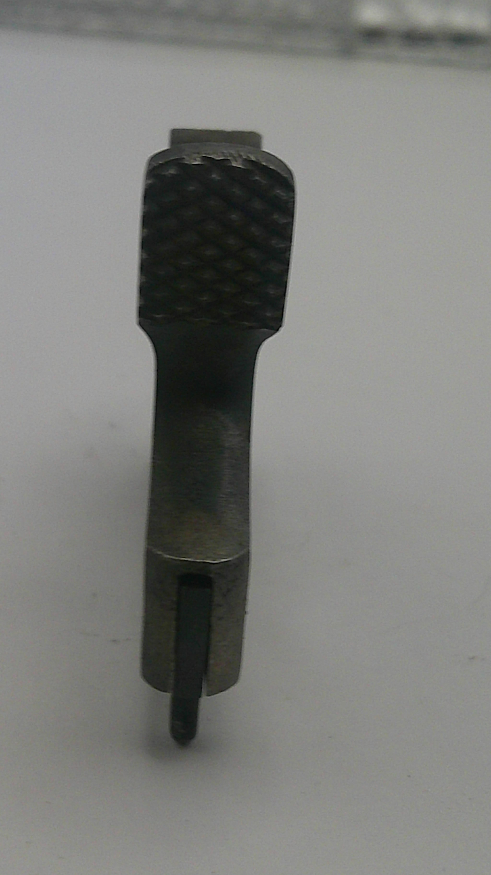 Black metal tool bit on a white background