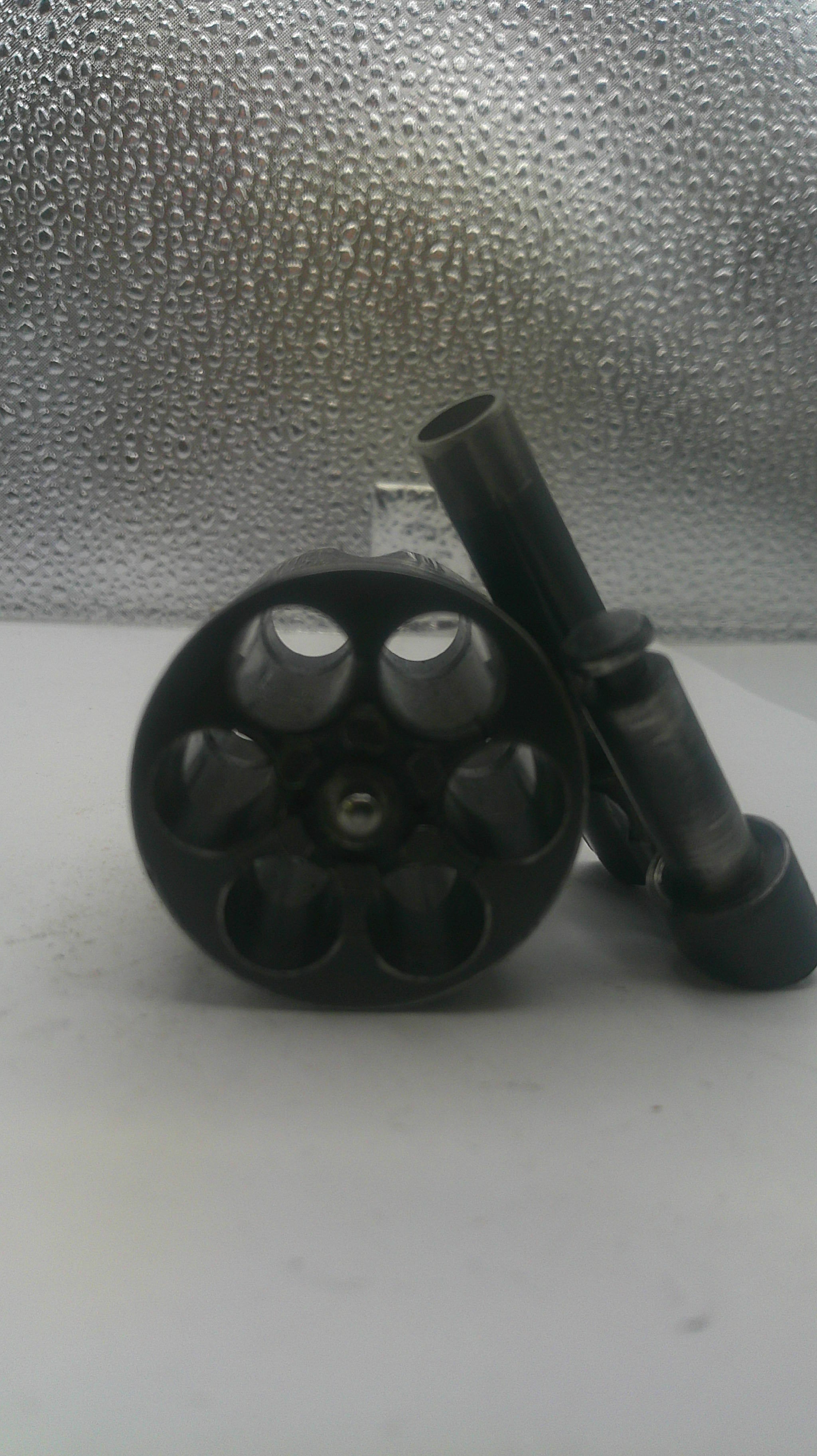 Black mechanical component on a textured surface
