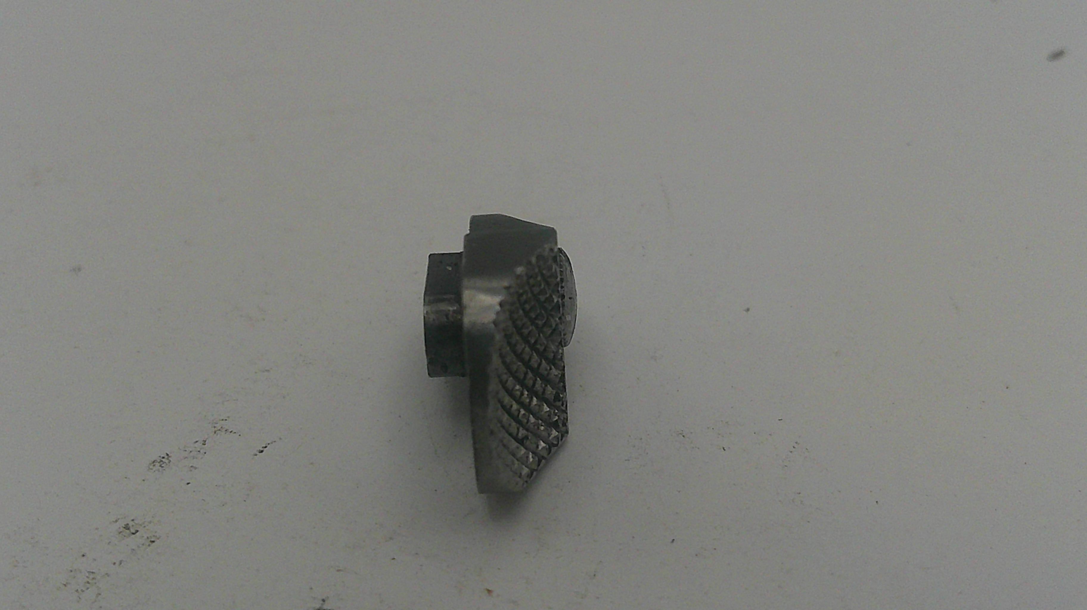 Metallic object on a light gray background