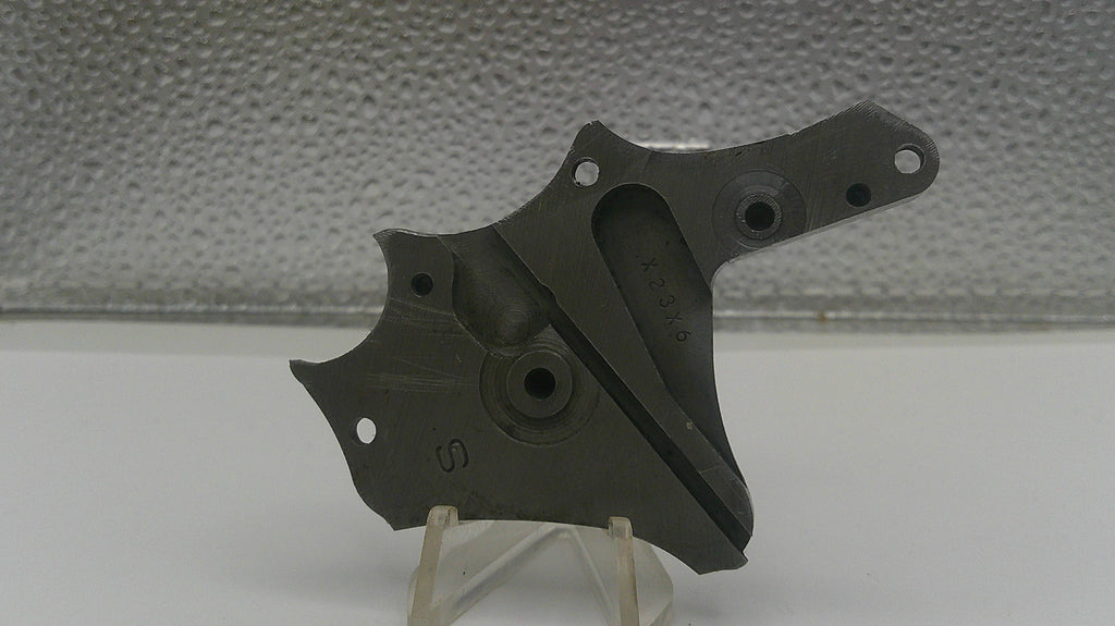 Black metal bracket on a stand against a textured gray background