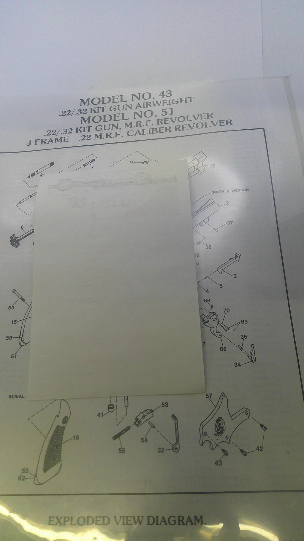Technical diagram with text and a blank sheet of paper overlayed