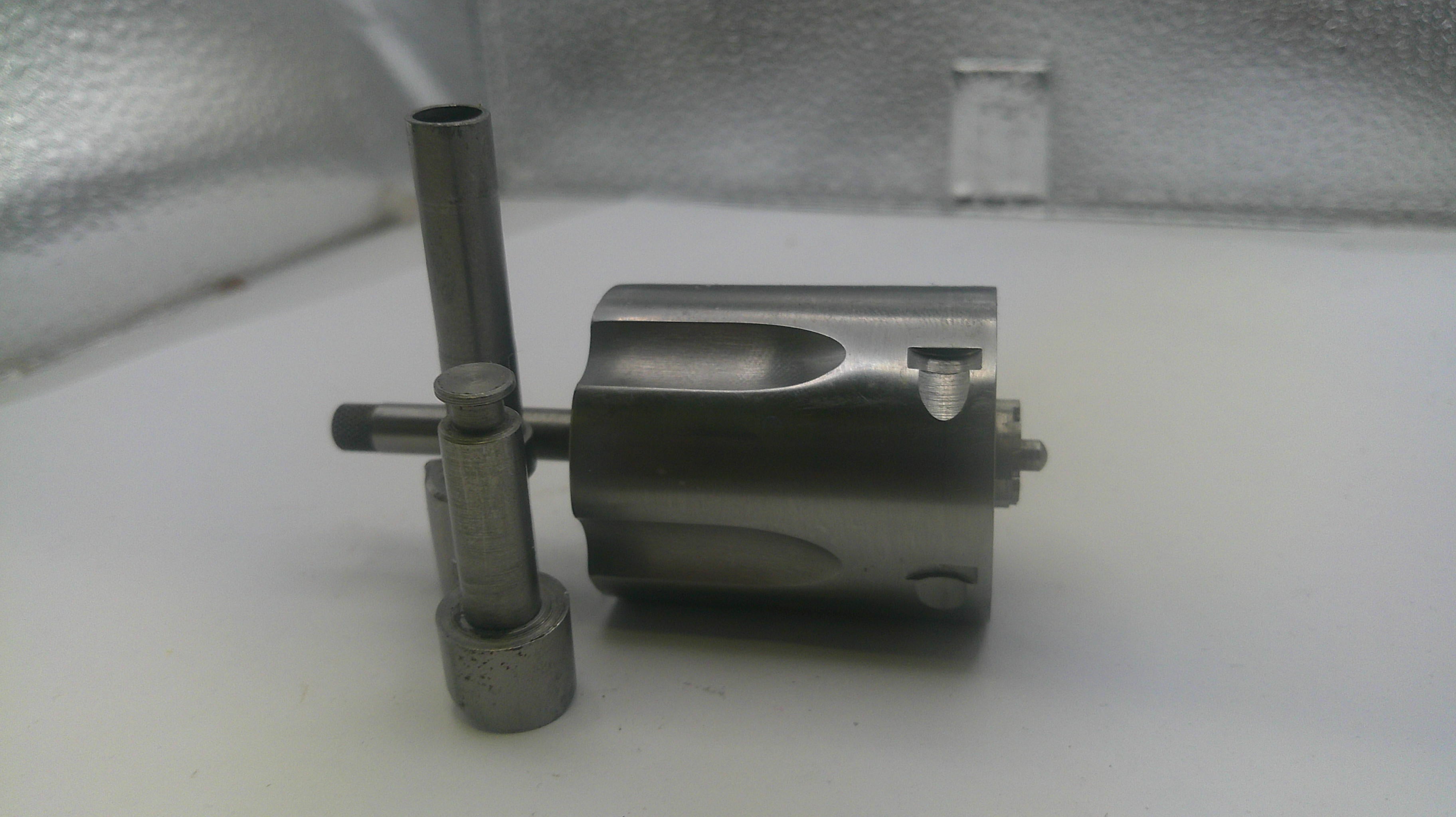 Metal mechanical component on a white surface with a blurred background