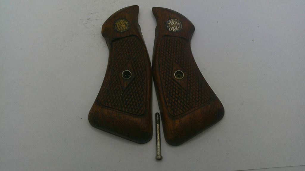 Two brown gun grips with a screw on a white background