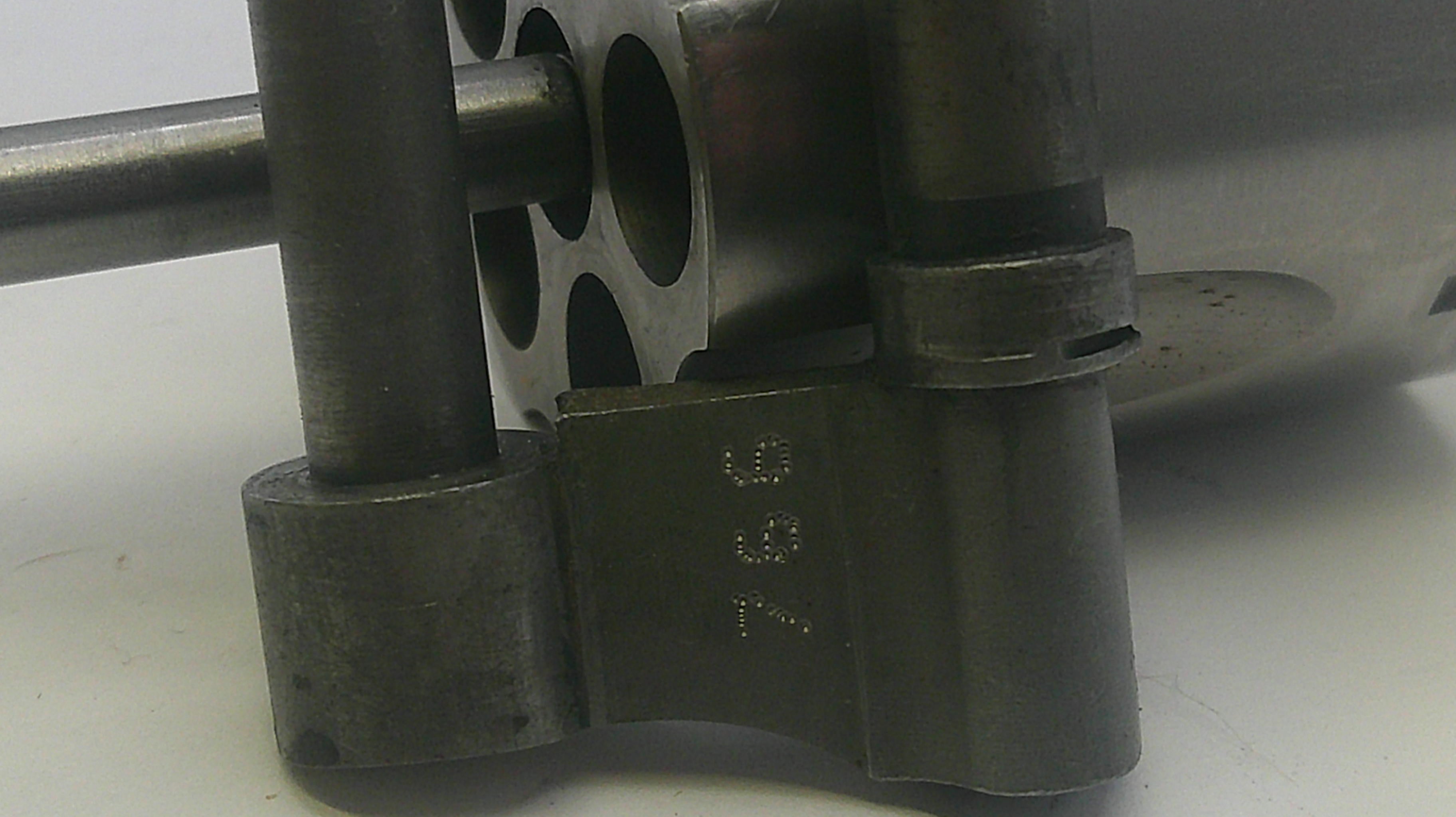 Close-up of a mechanical component with '091' marking on a white background