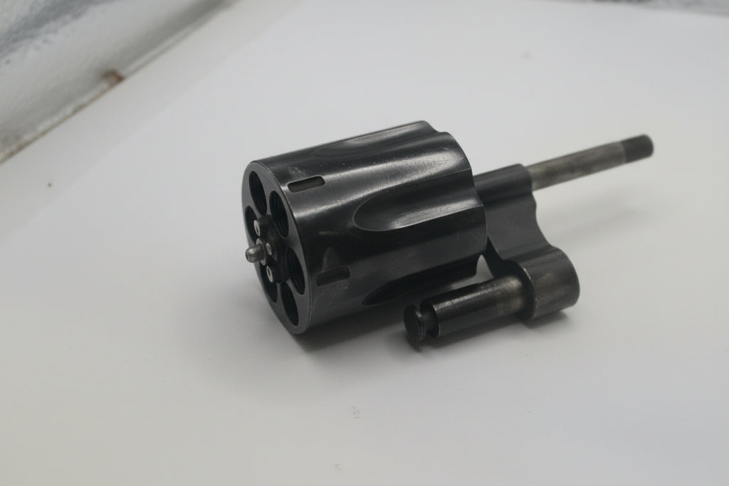 Black mechanical component on a white surface