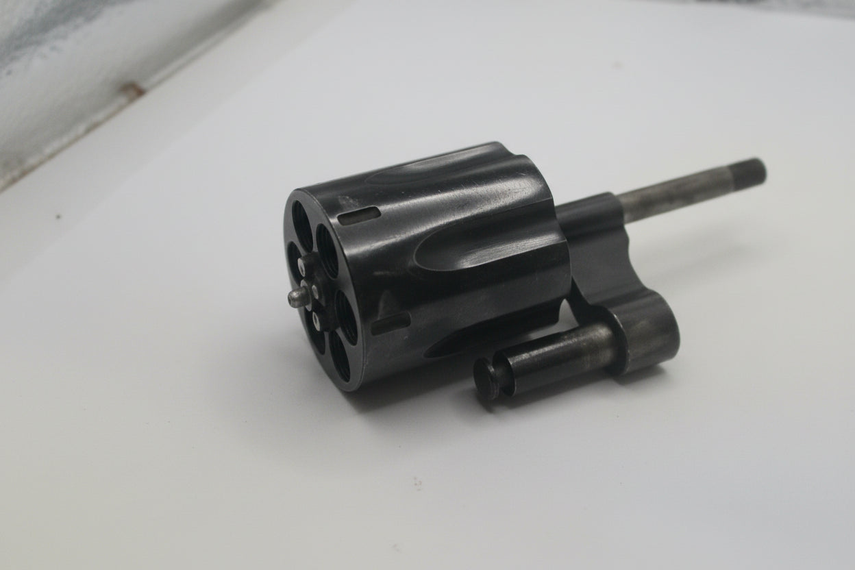 Black mechanical component on a white surface