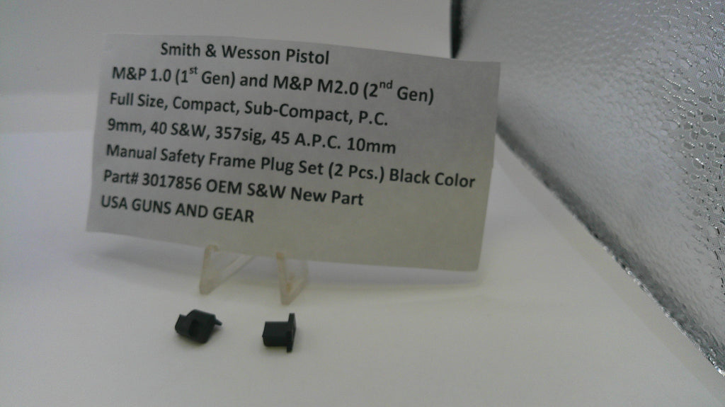 Smith & Wesson pistol parts on a white surface with a label detailing product information.