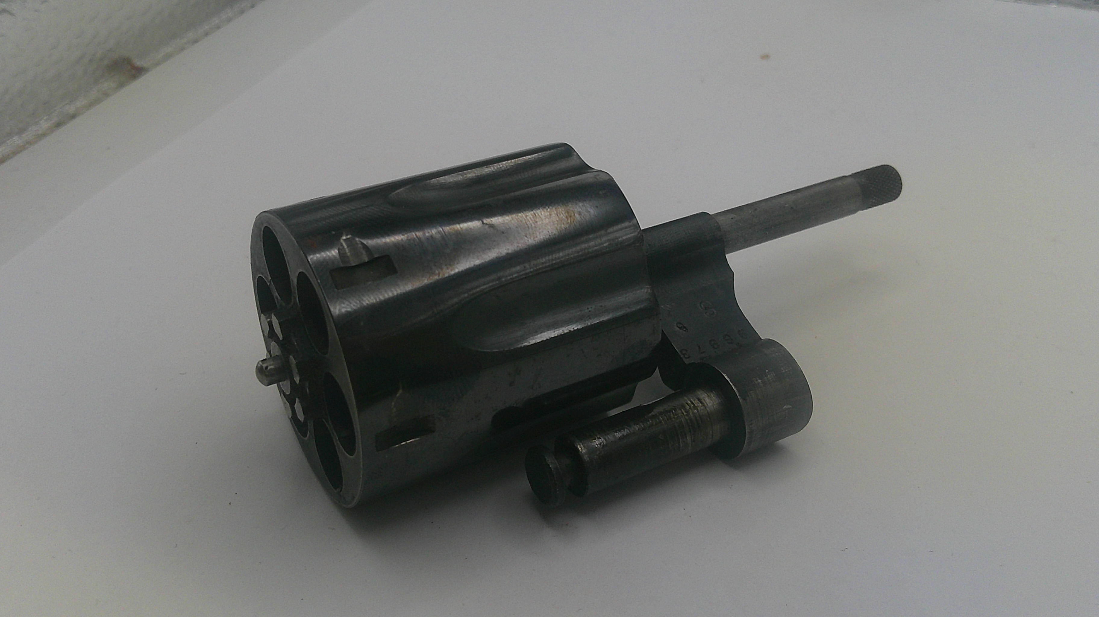 Black mechanical component on a white surface