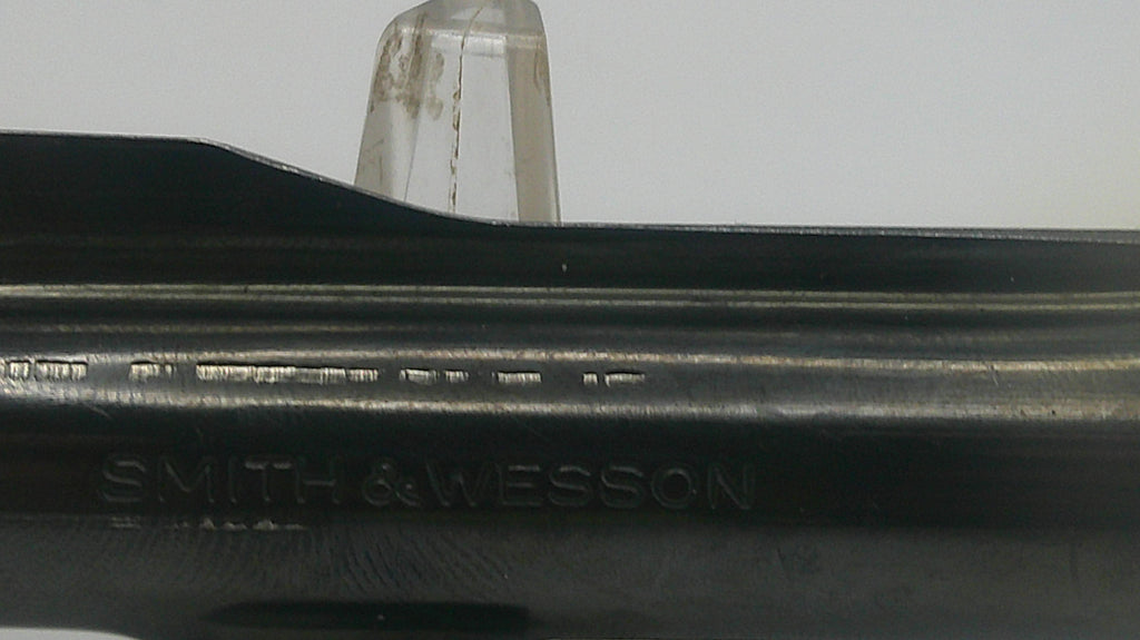 Close-up of a Smith & Wesson firearm with a blurred background