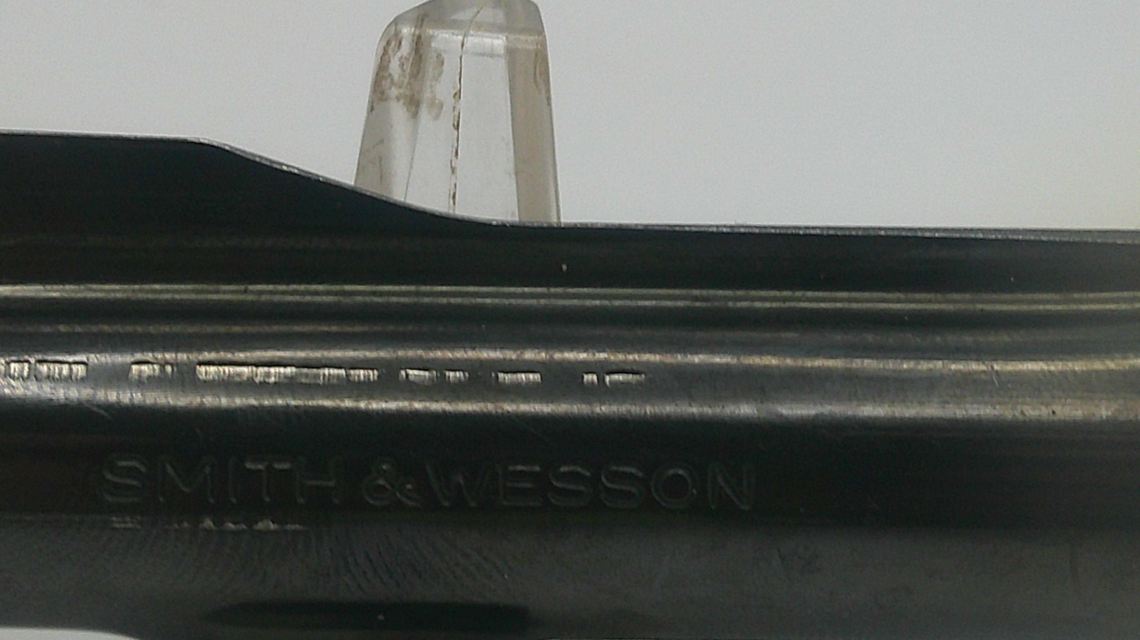 Close-up of a Smith & Wesson firearm with a blurred background