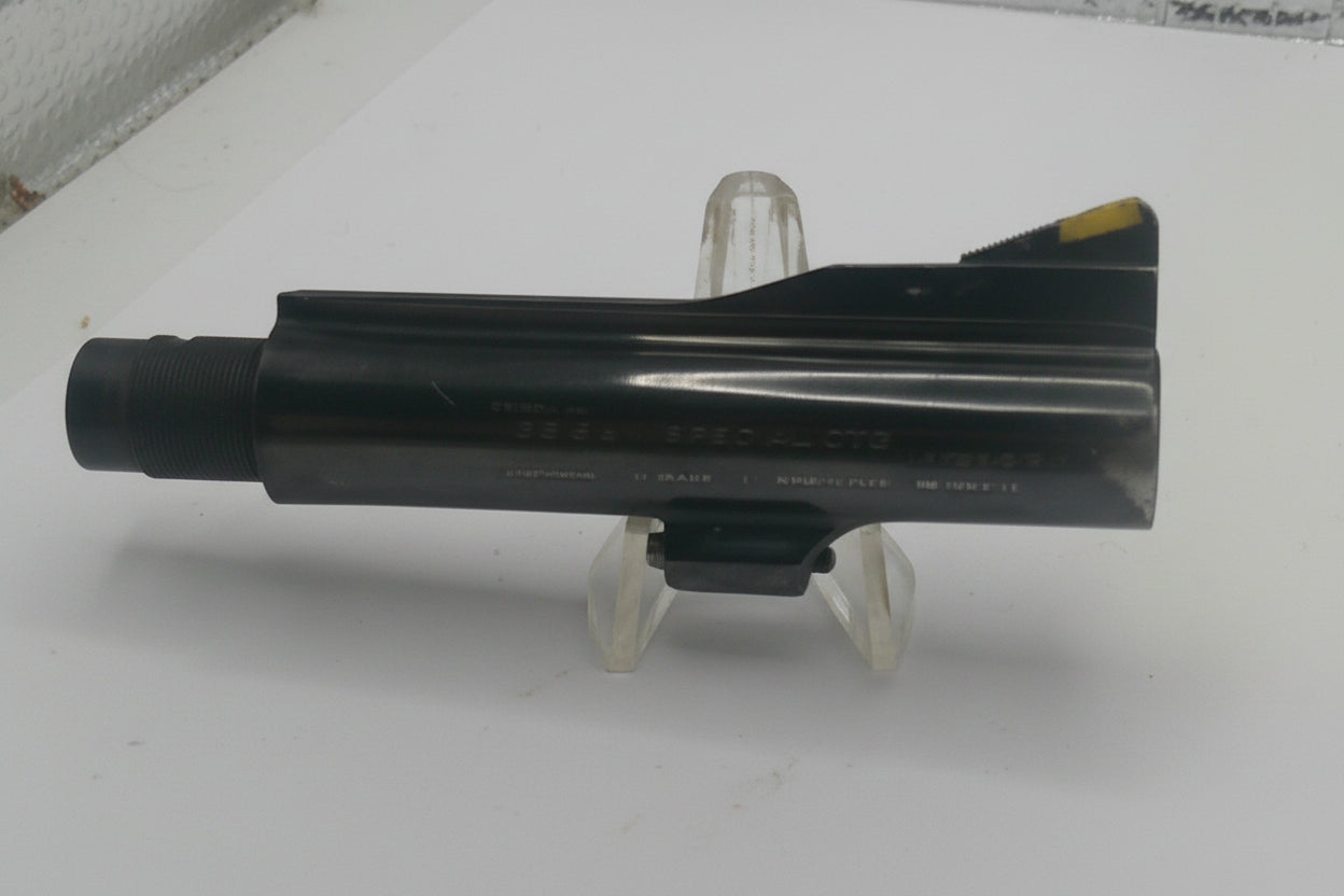Black metal object on a stand against a white background