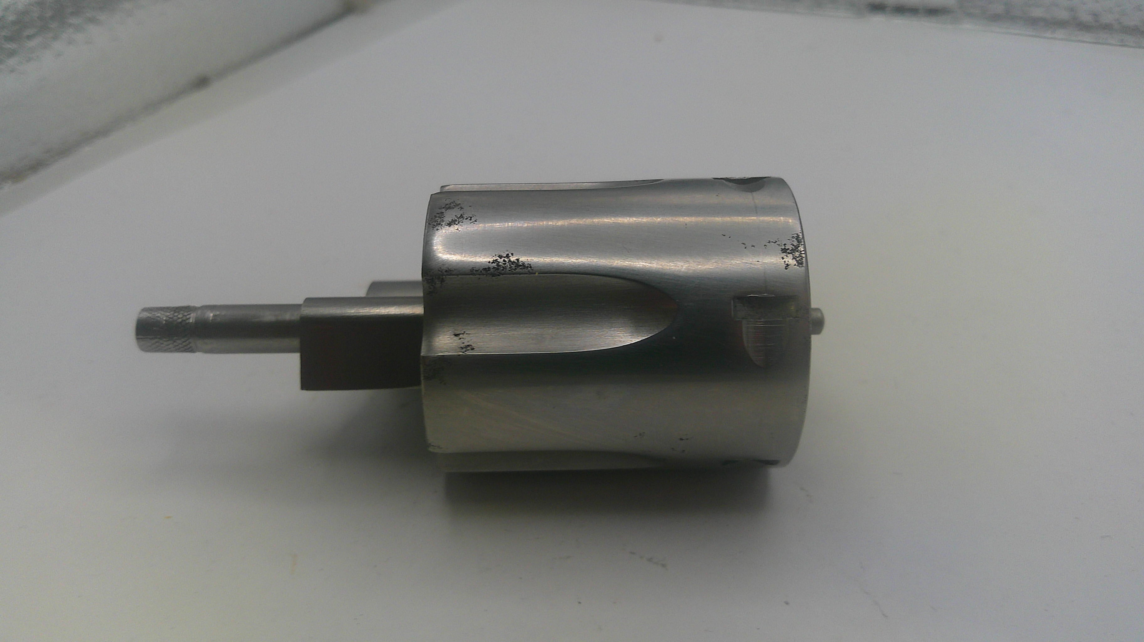 Metal cylindrical component on a white surface