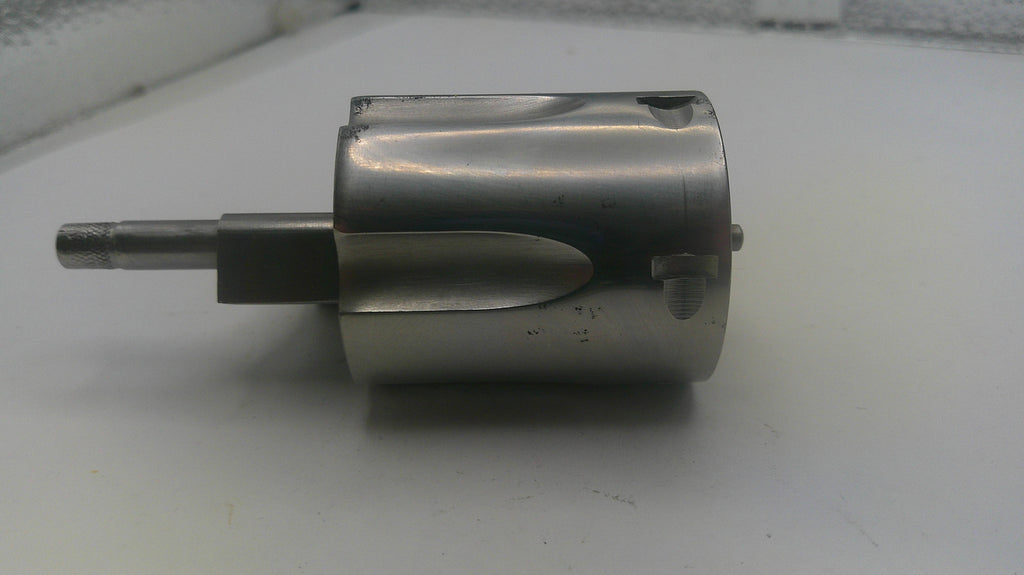 Metal cylindrical component on a white surface