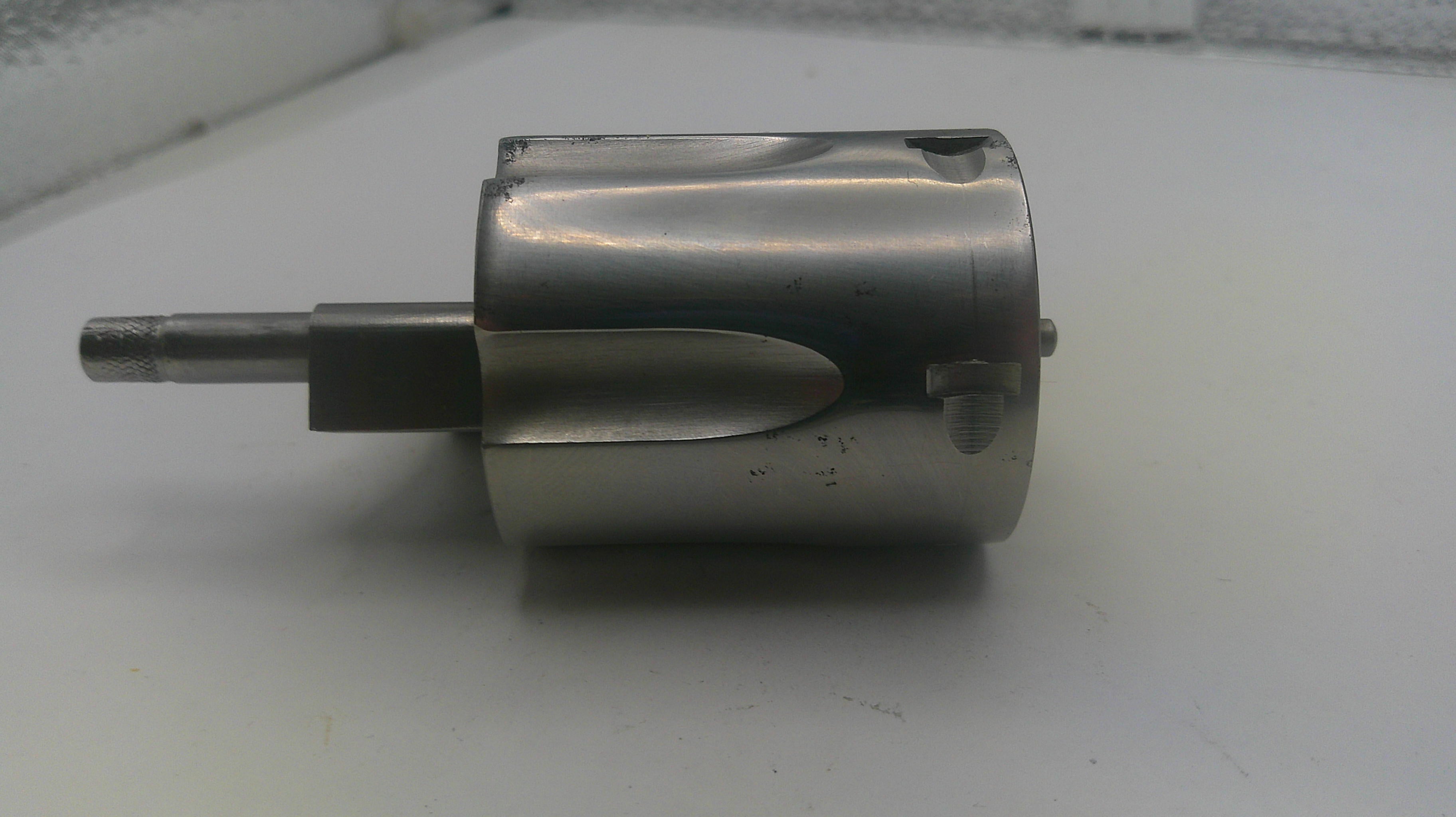 Metal cylindrical component on a white surface