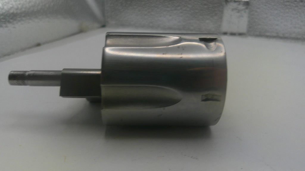 Metal component on a white surface with a neutral background