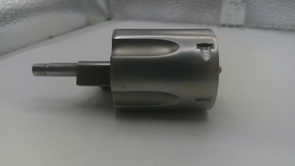Metallic cylindrical component on a white surface