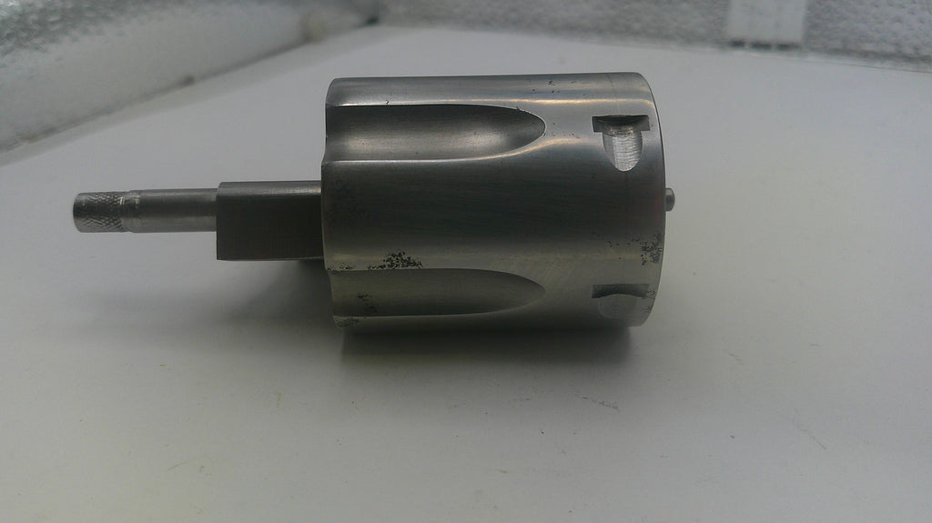 Metal cylindrical component on a white surface