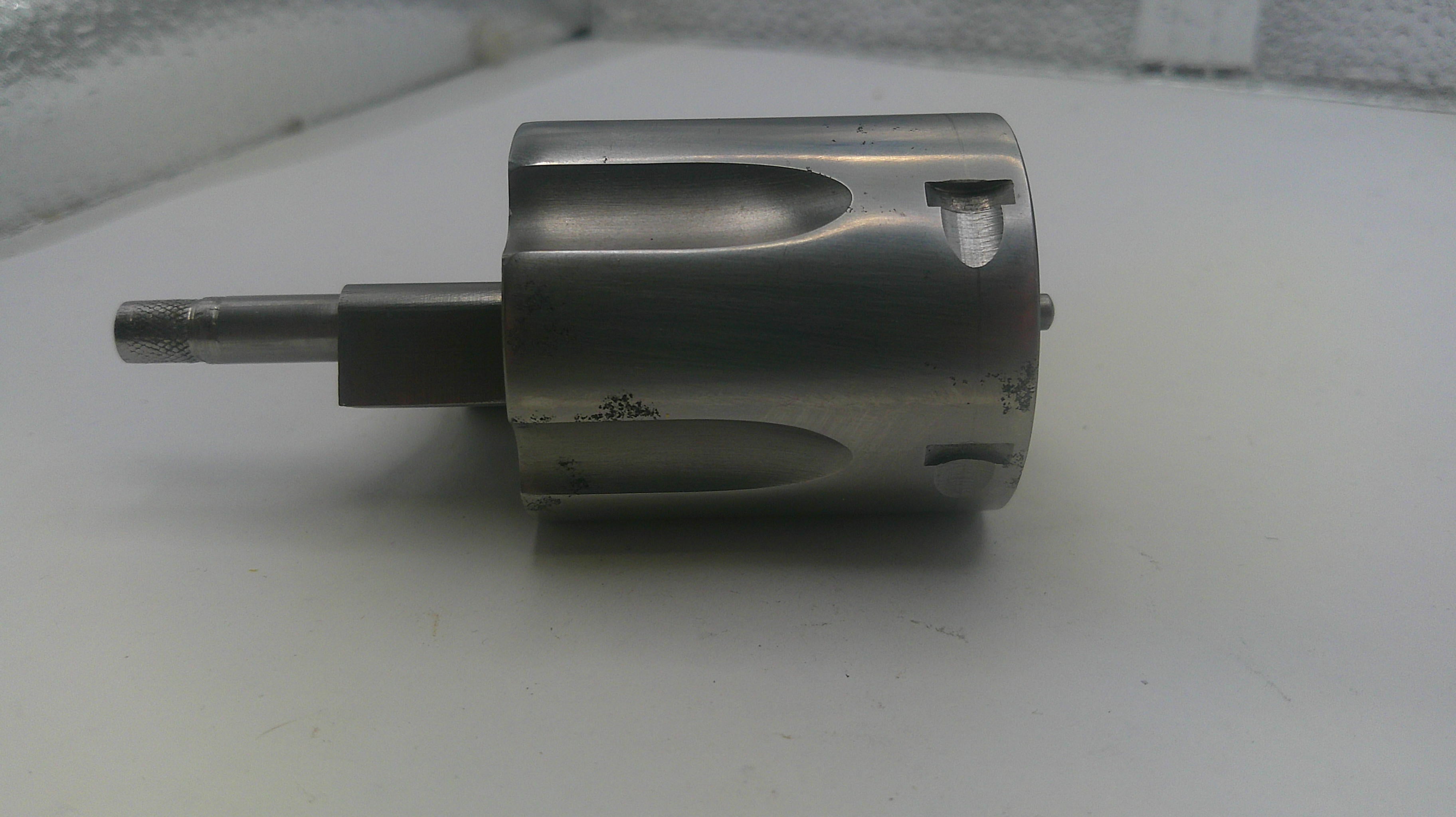 Metal cylindrical component on a white surface