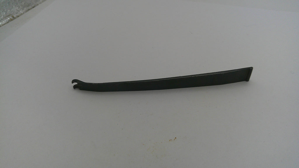 Black metal tool on a white surface
