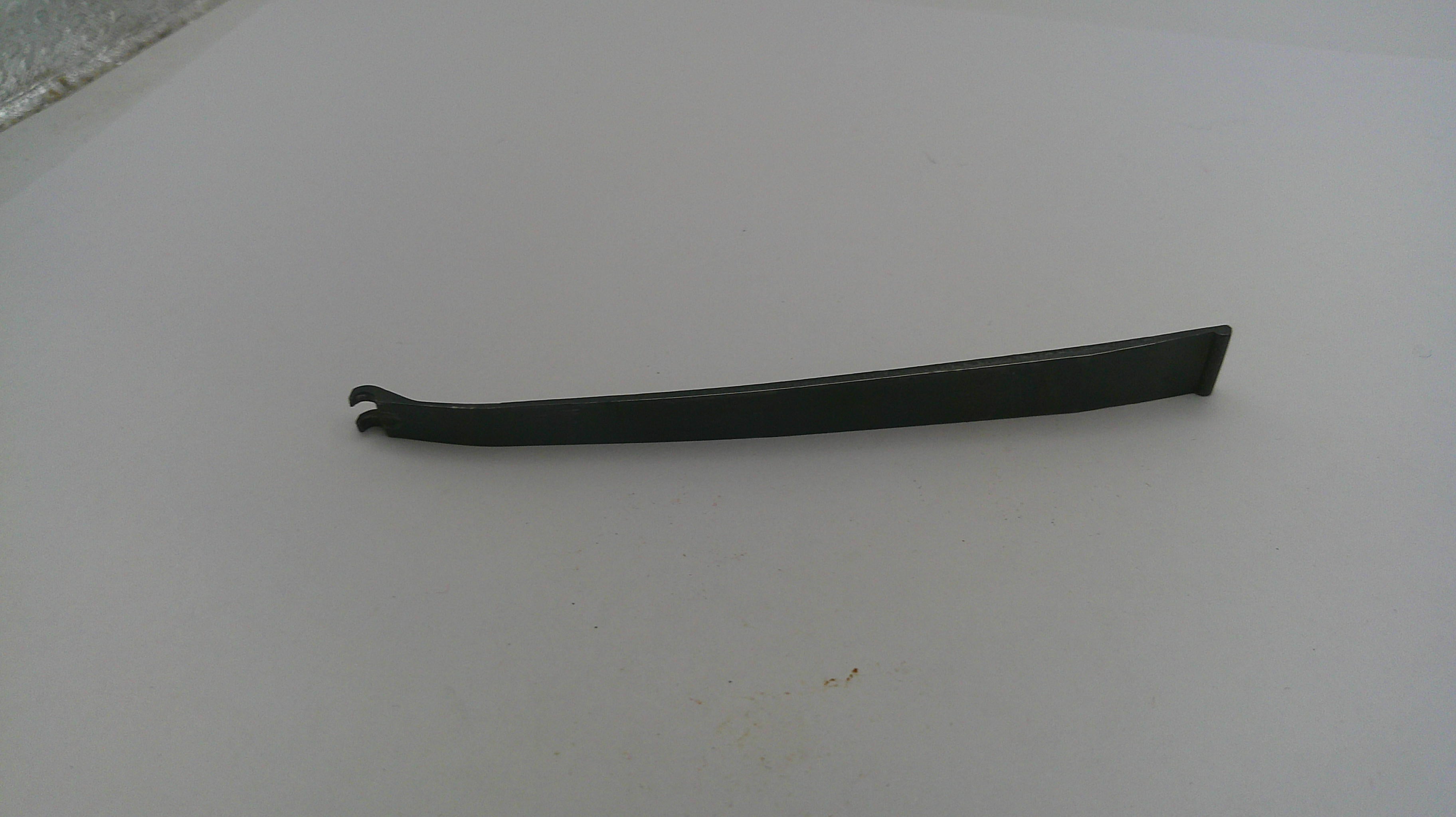 Black metal tool on a white surface