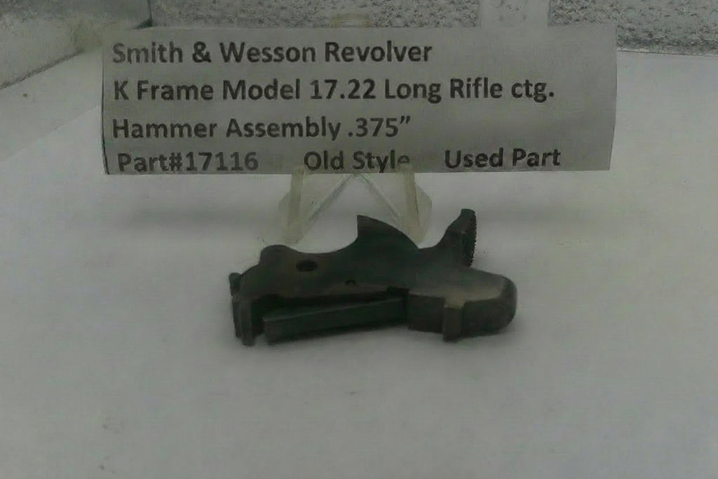 Smith & Wesson revolver hammer assembly on a white background with a label.