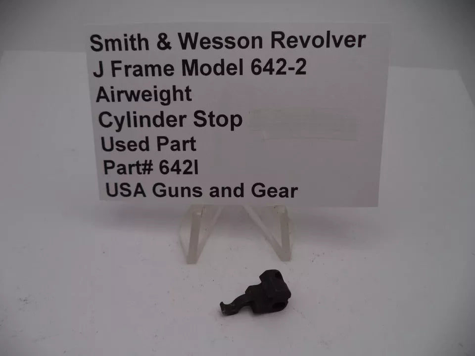 Smith & Wesson J Frame Model 642-2 Airweight Cylinder Stop, used part, displayed on a white surface with a sign detailing the product information.