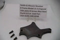 Smith & Wesson revolver K Frame Model 15 .38 Special side plate and screws on a white background with a label.