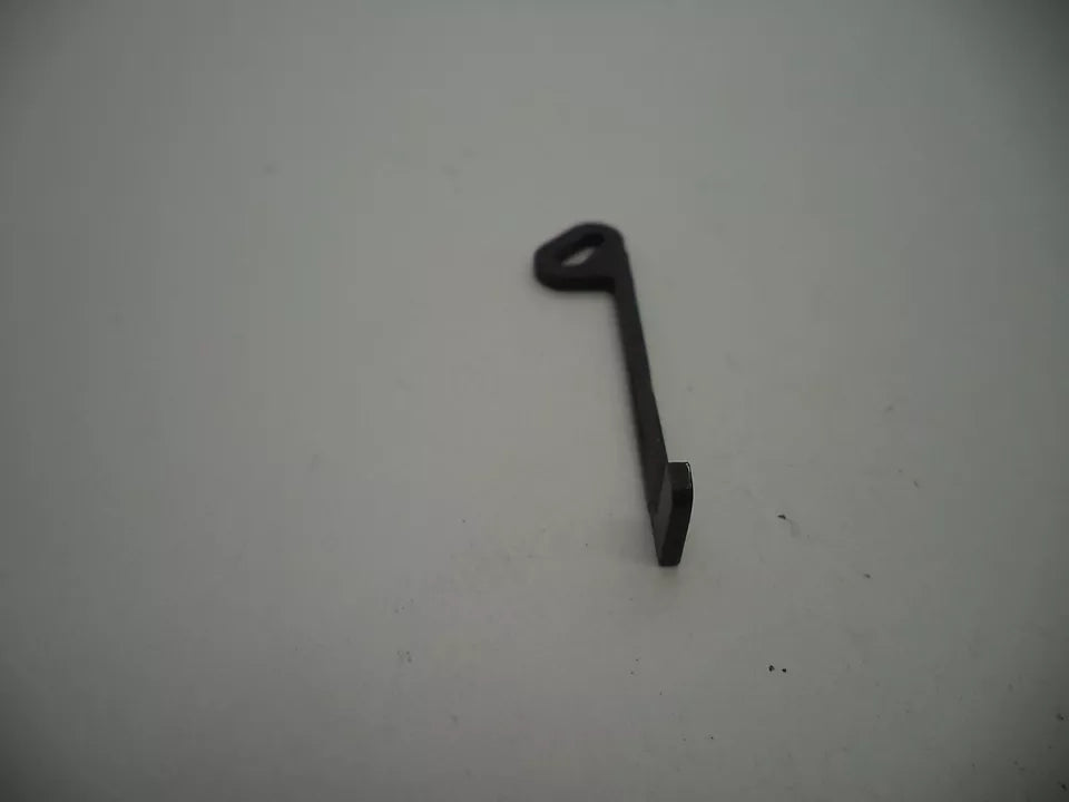 Black metal key-shaped object on a white background