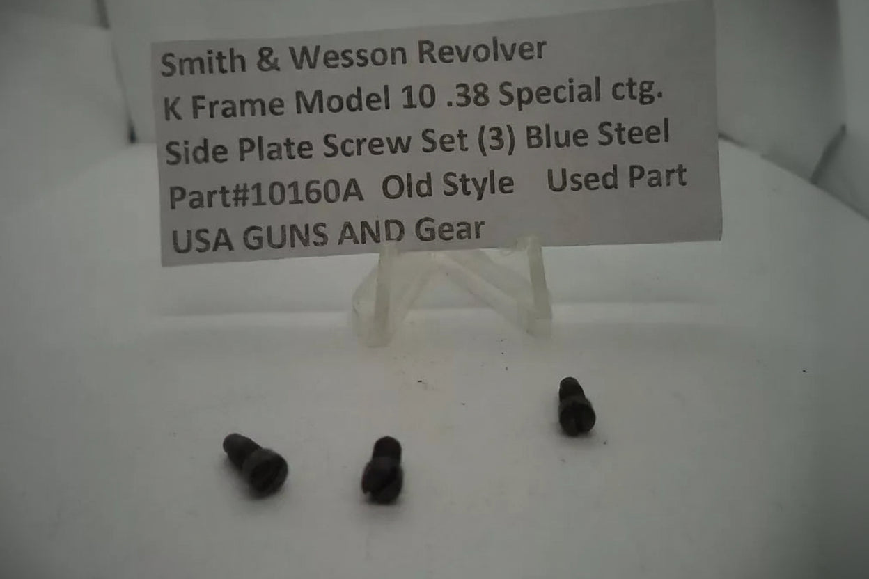 Three side plate screws for a Smith & Wesson revolver on a white surface with a label.