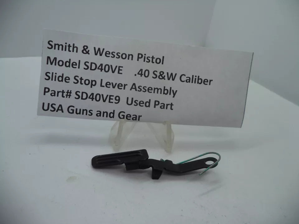 Smith & Wesson Pistol Model SD40 VE Slide Stop Lever Assembly for .40 S&W displayed on a white background with a descriptive label in front.