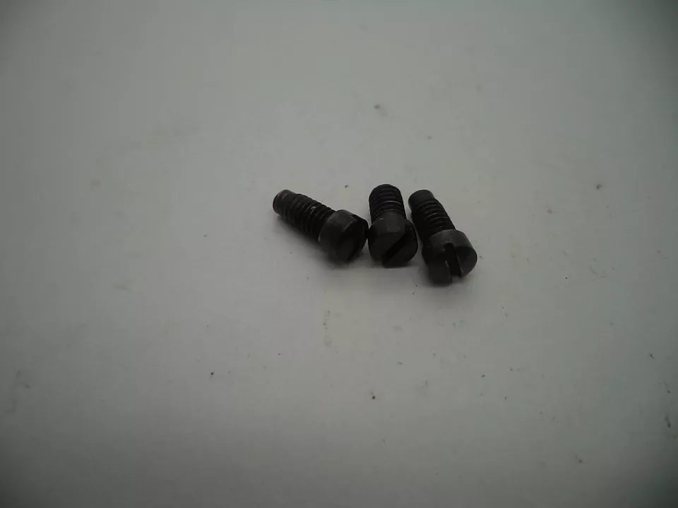 Three black screws on a light gray background