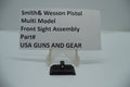 Smith & Wesson Pistol Multi Model Front Sight Assembly, part number 239430000, displayed on a white stand with pricing and product information sign above it.