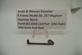 Smith & Wesson revolver hammer block part with descriptive label on a white background