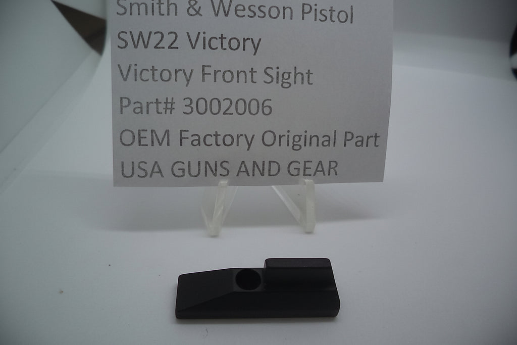 Smith & Wesson SW22 Victory front sight displayed on a stand with a label indicating it is an OEM Factory Original part, intended for use with US guns and gear.