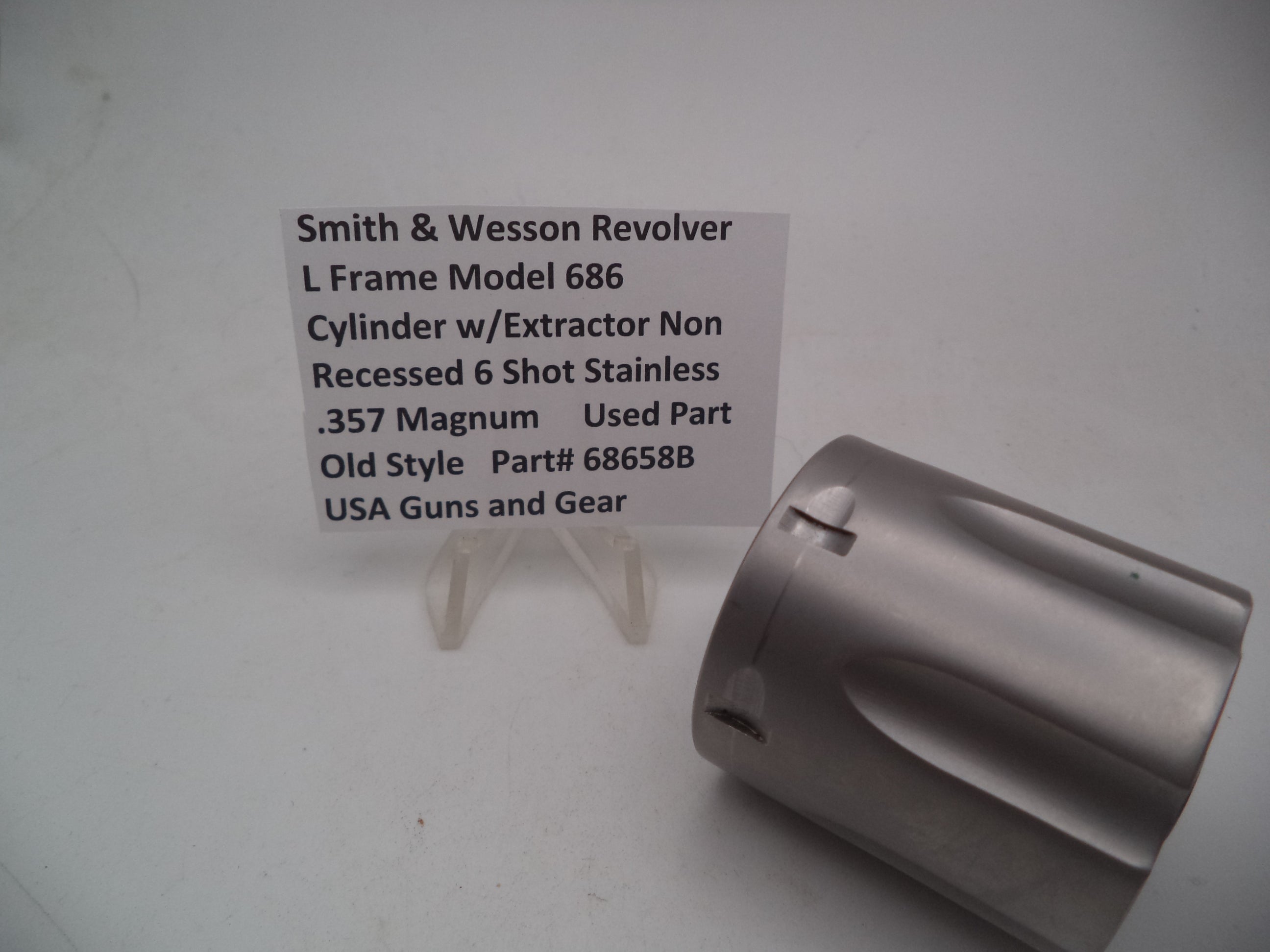 A Smith & Wesson revolver L Frame Model 686 cylinder with extractor, non-recessed .357 Magnum used part, displayed on a white background.