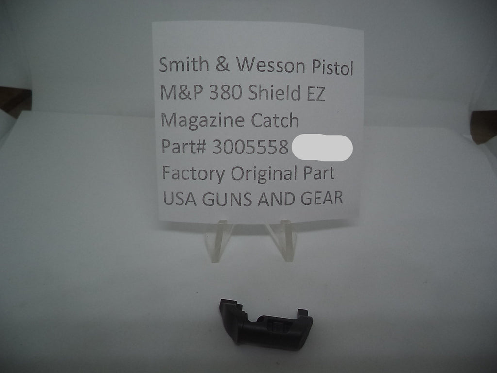 A black magazine catch for a Smith & Wesson M&P 380 Shield EZ pistol, displayed on a white background with a label indicating the part number 3005558 and the price of $6.99.