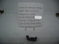 A black magazine catch for a Smith & Wesson M&P 380 Shield EZ pistol, displayed on a white background with a label indicating the part number 3005558 and the price of $6.99.