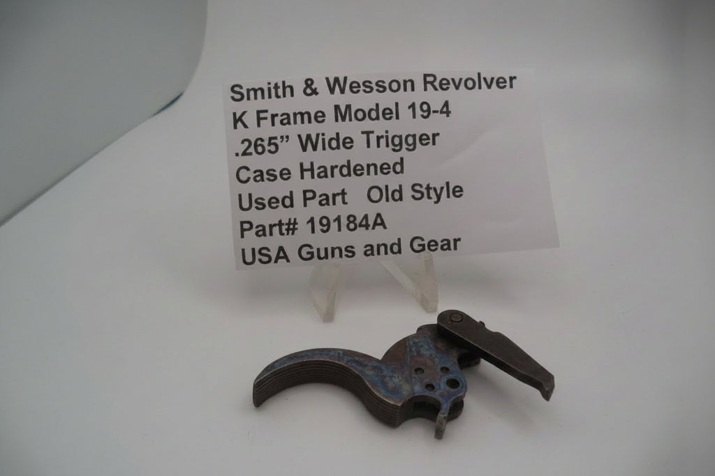 Smith & Wesson revolver trigger part with descriptive label on a white background