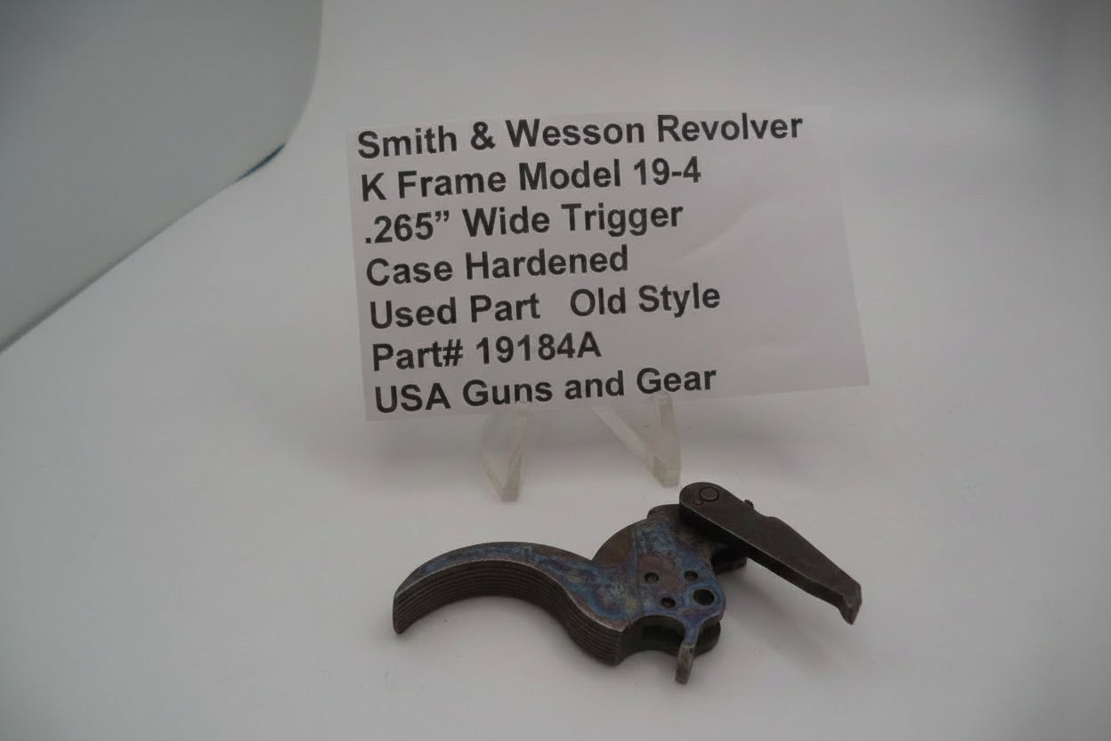 Smith & Wesson revolver trigger part with descriptive label on a white background