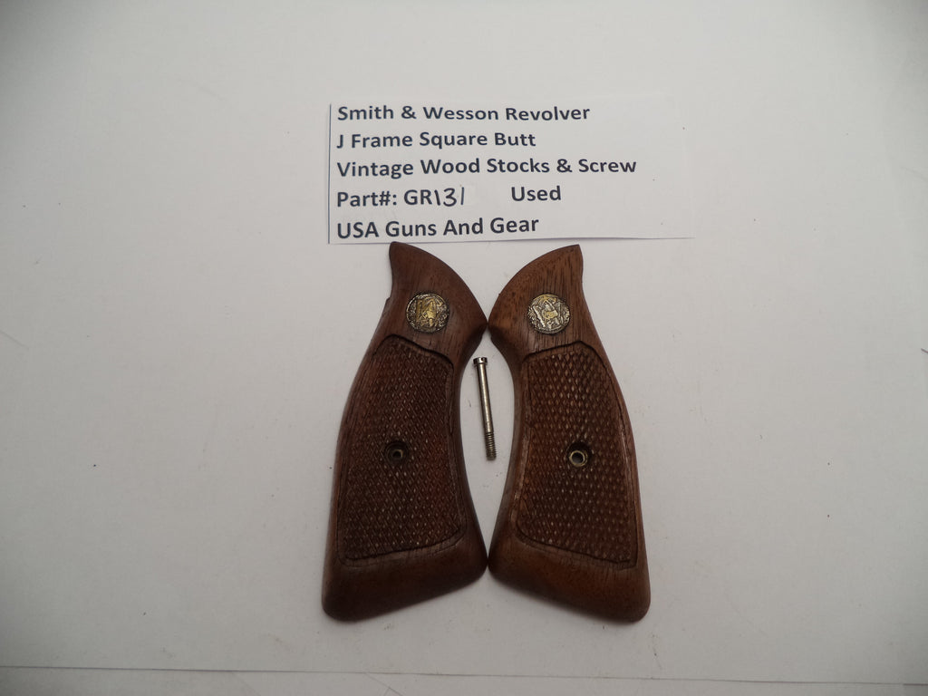 Two brown vintage wood grips for a Smith & Wesson revolver laid on a white surface with a paper that reads 'Smith & Wesson Revolver J Frame Square Butt Vintage Wood Stocks & Screw'.