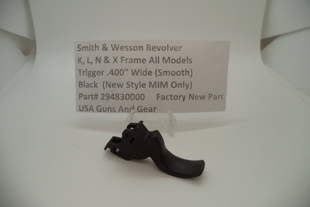 Black gun trigger on a white background with a label detailing product information.