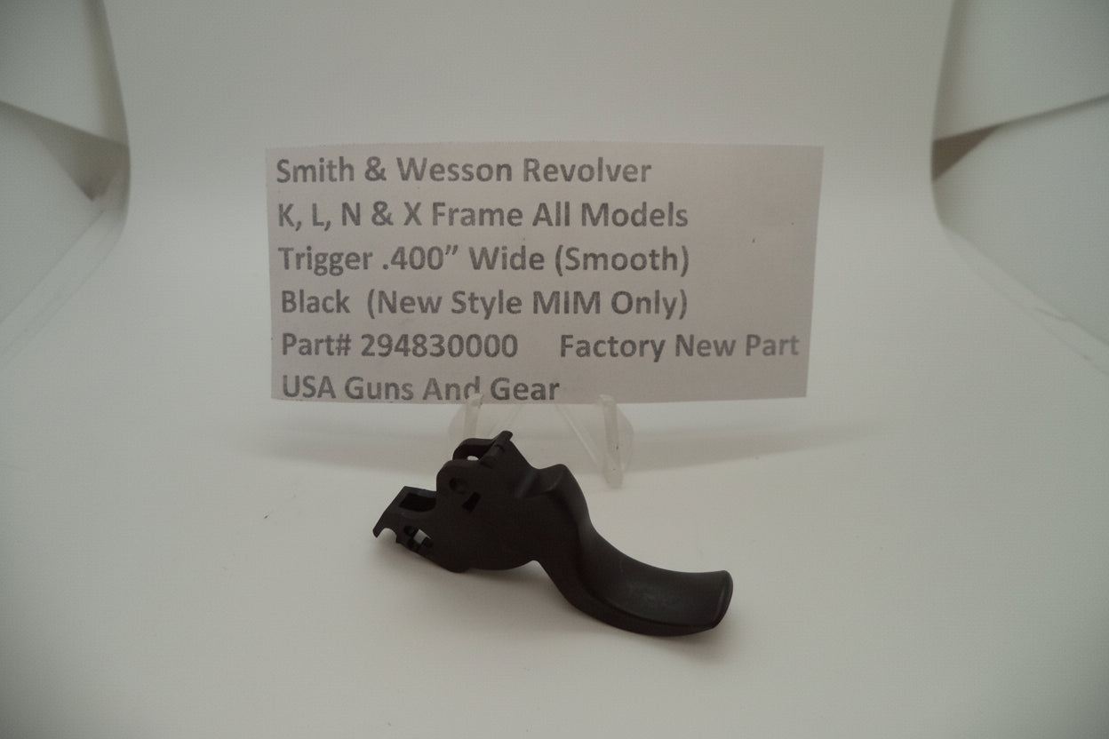 Black gun trigger on a white background with a label detailing product information.